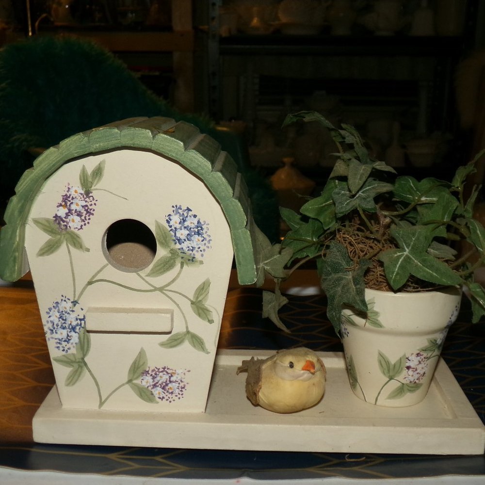 wooden bird house with a pot & bird.